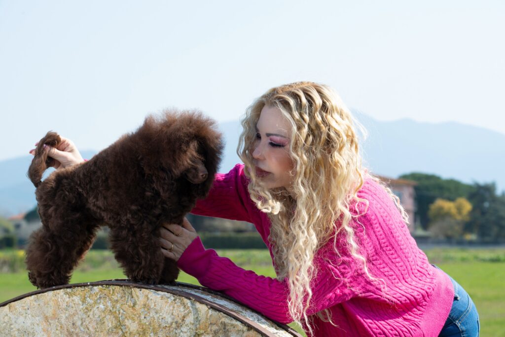 woman an toy poodle