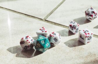 A set of seven Dungeons and Dragons dice on a white tiled floor.