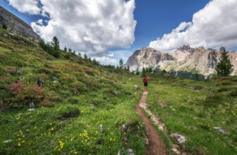 Person walking on an ancient hill pilgrimage trail in Europe