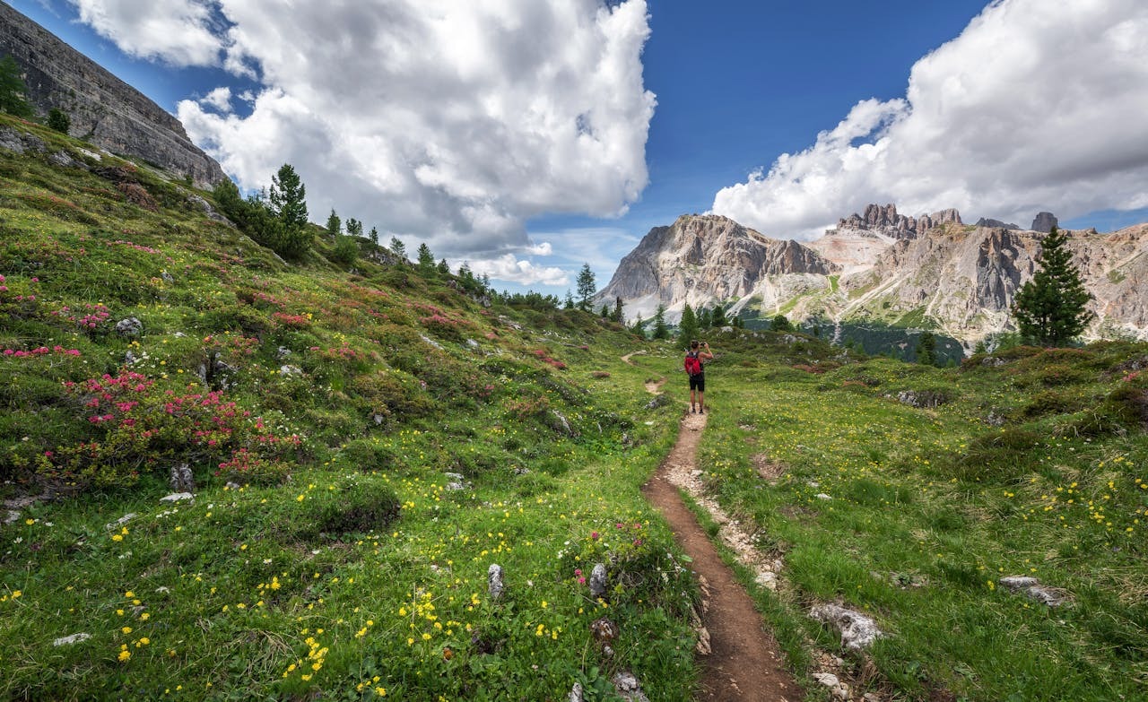 Person walking on an ancient hill pilgrimage trail in Europe