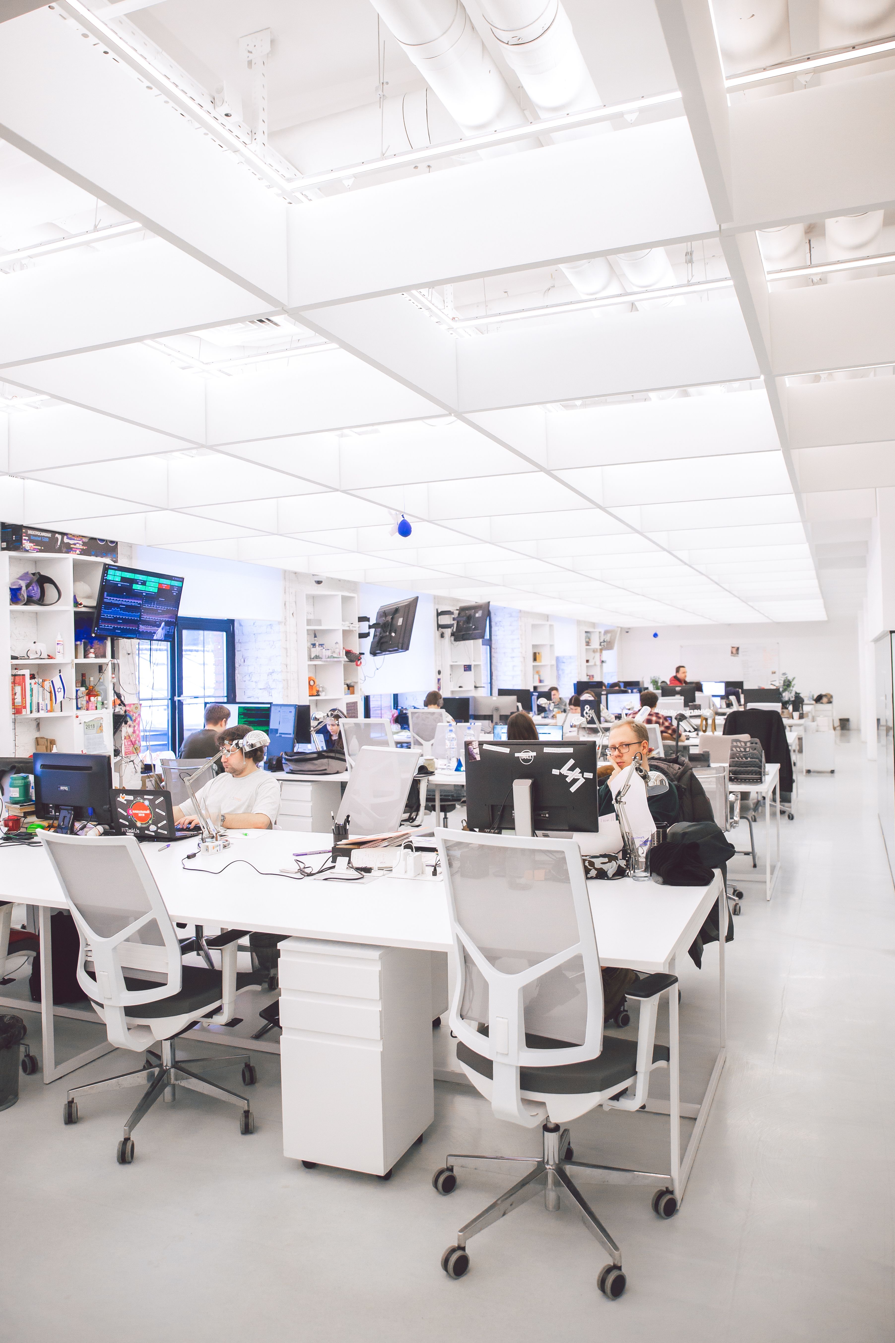 Bright modern office with employees working at desks in an open contemporary design