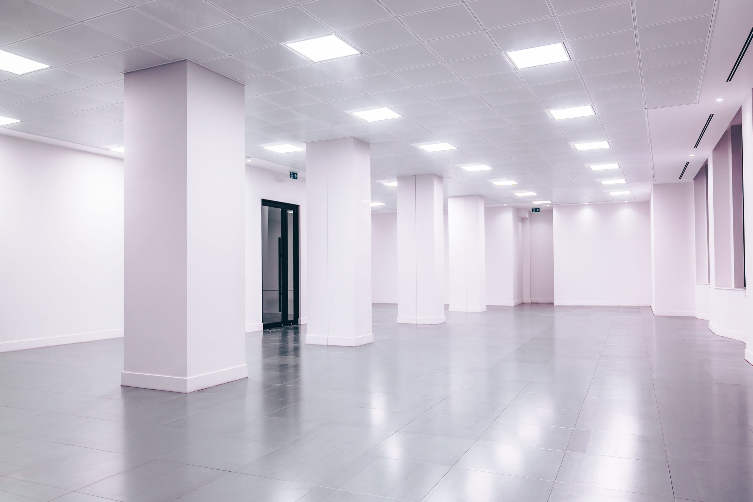 Bright minimalist office interior with clean lines and ample lighting, showcasing a tidy workspace