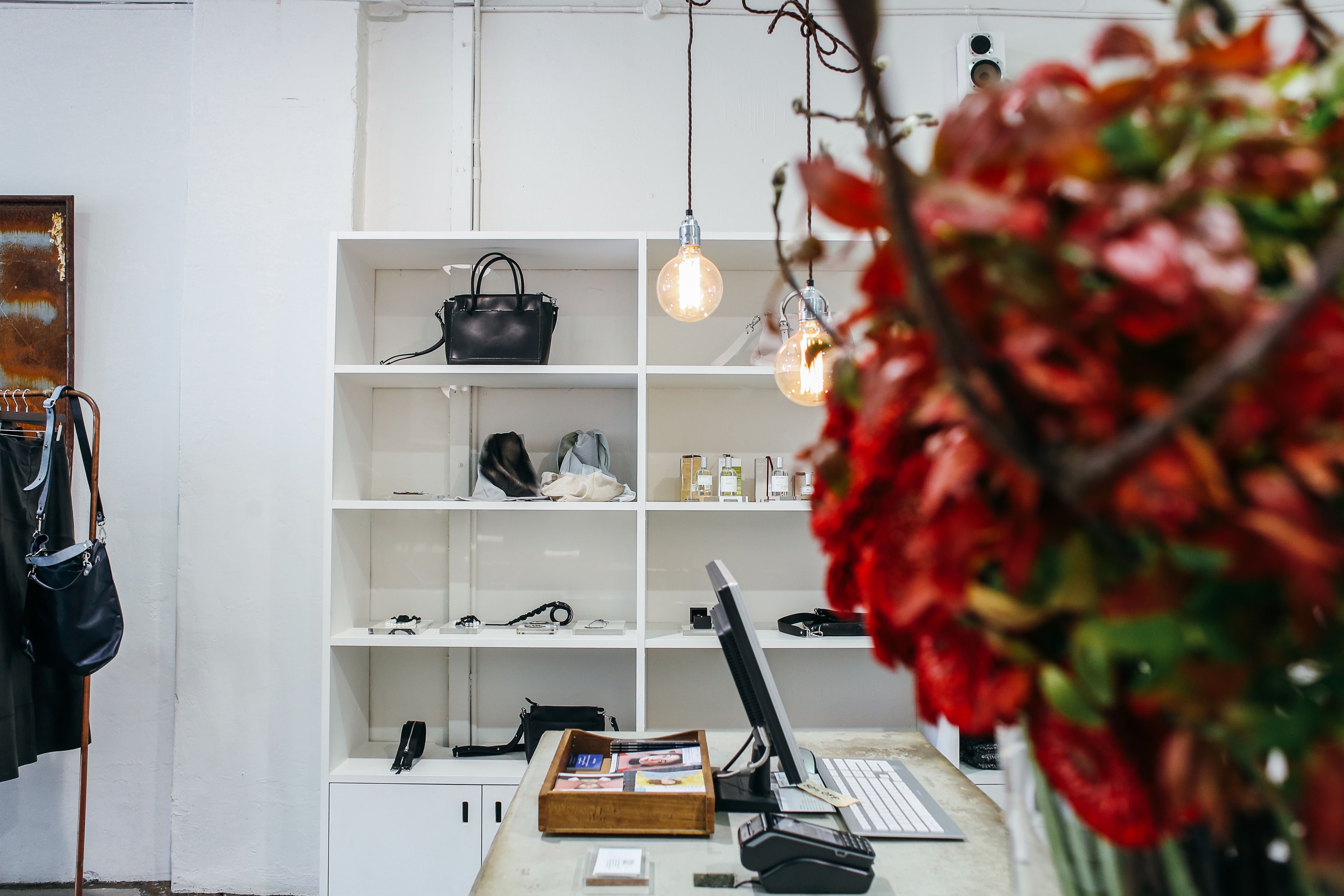 Contemporary retail shop interior with display shelves of bags and perfumes