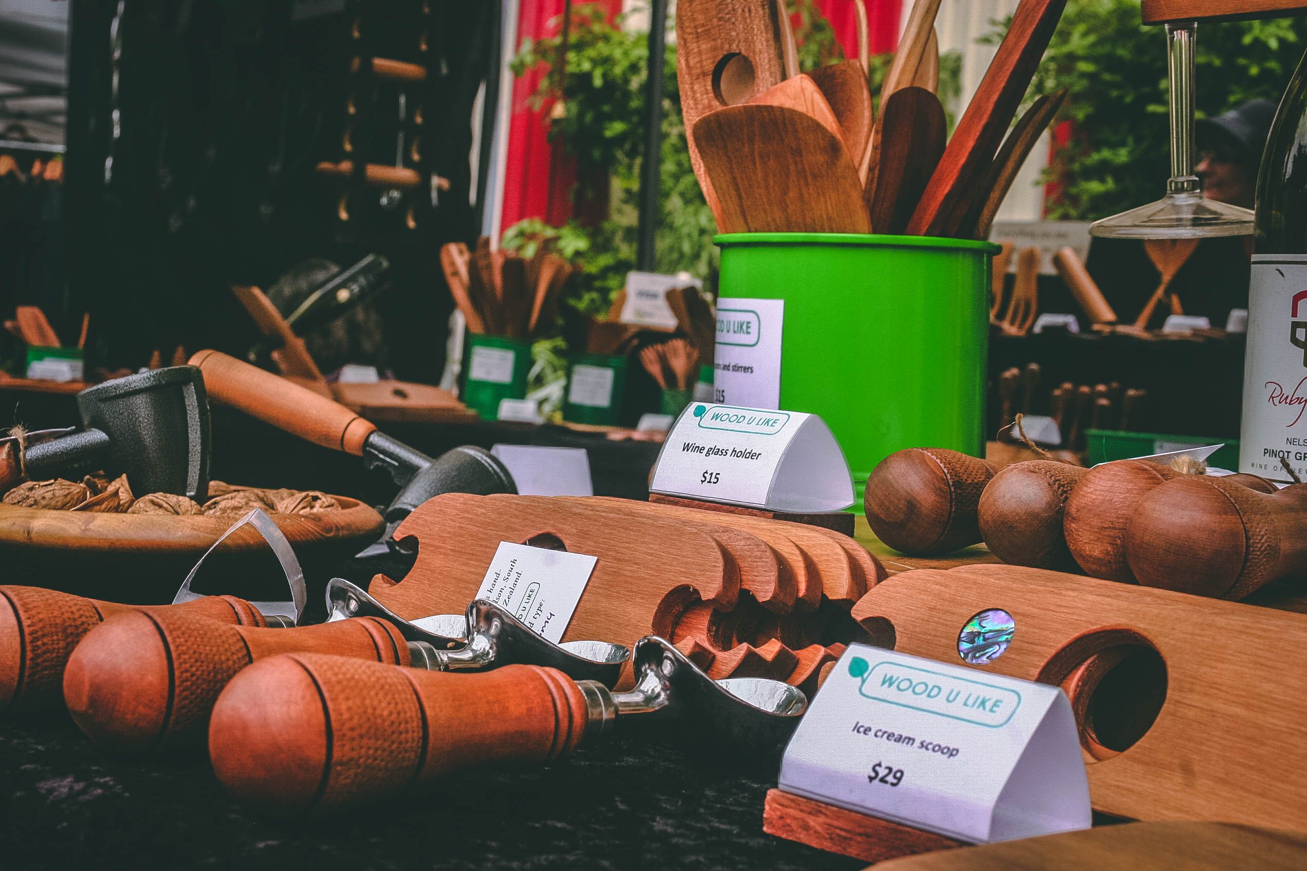 Handcrafted wooden kitchen utensils artfully displayed at an outdoor market stall