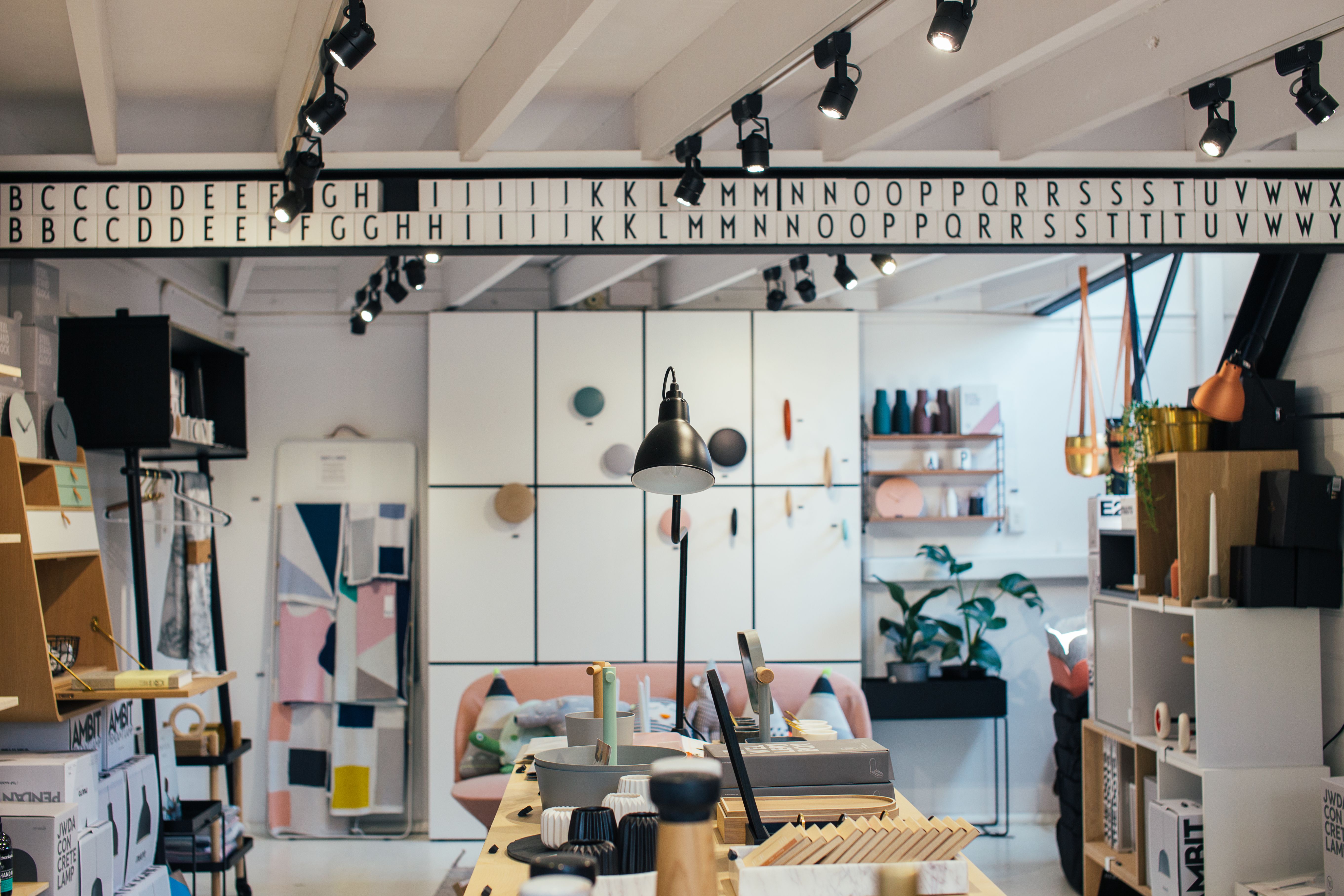 Creative retail display of home goods and gifts arranged on wooden shelves and containers