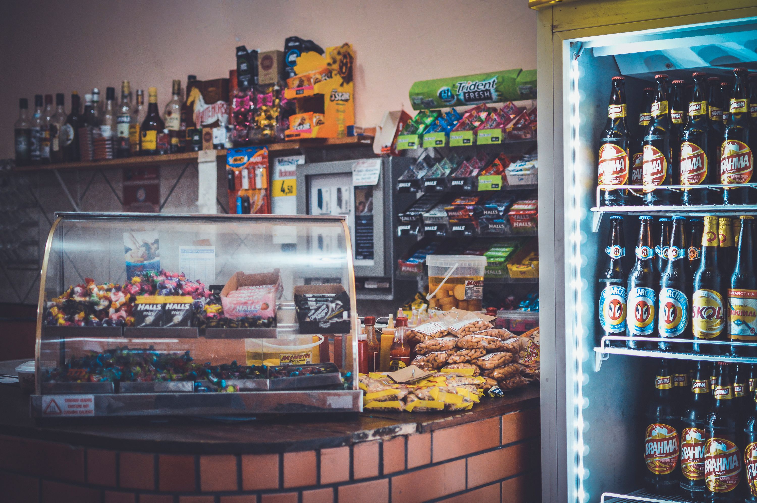 Well-stocked convenience store counter with snacks and drinks positioned for impulse buying at the register