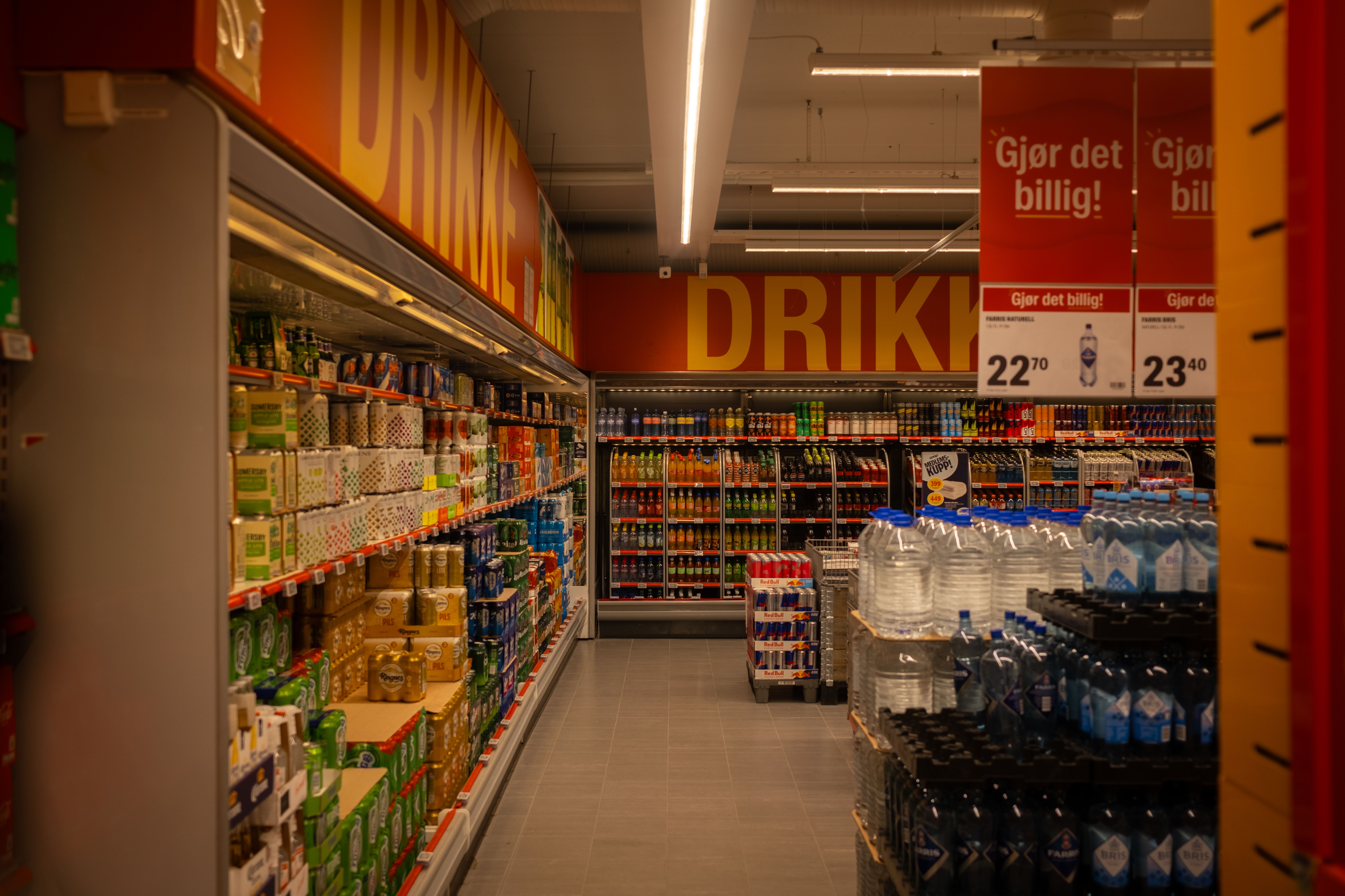 Colorful supermarket aisle with promotional signage promoting deals to influence shopper decisions